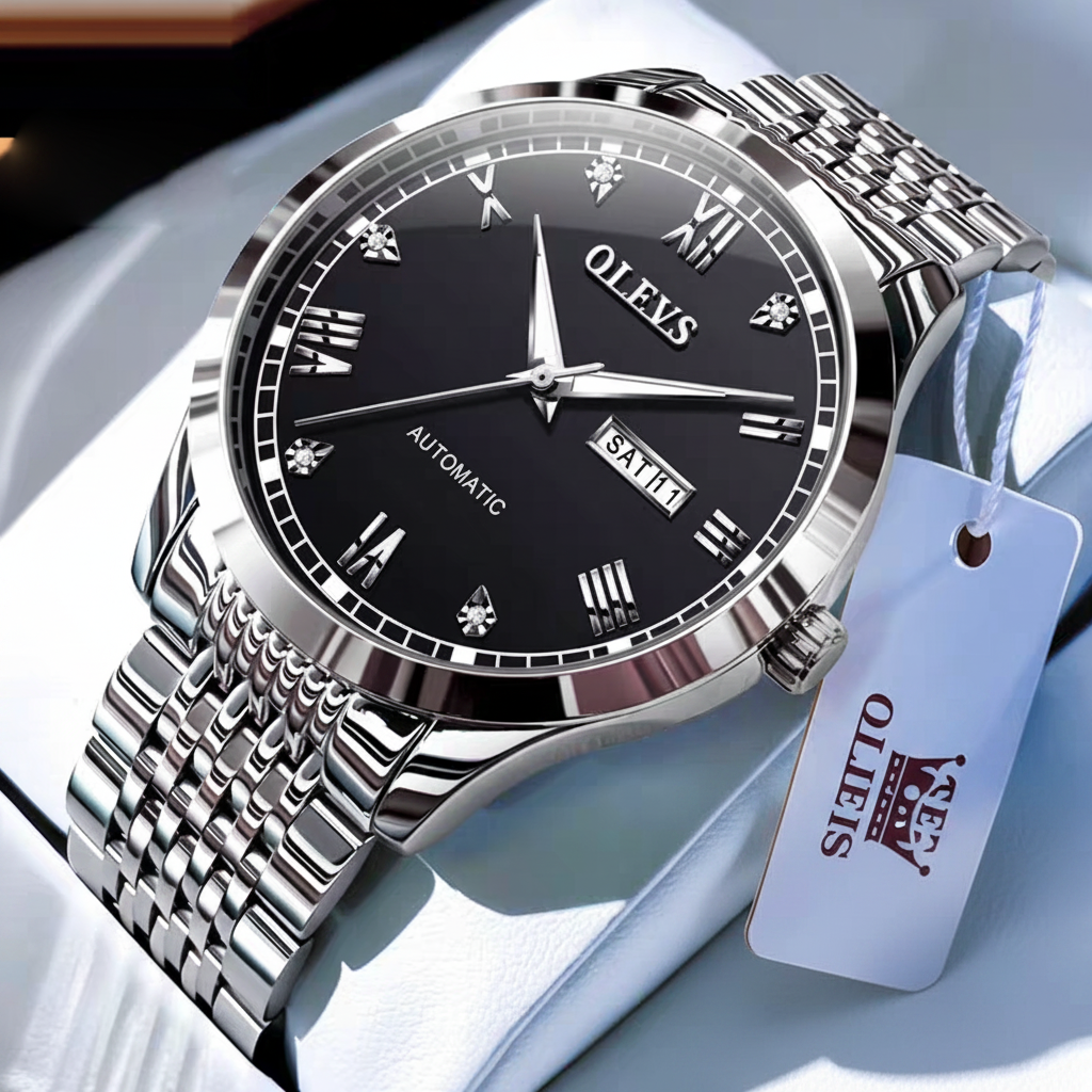 Silver watch with black dial on a white surface.