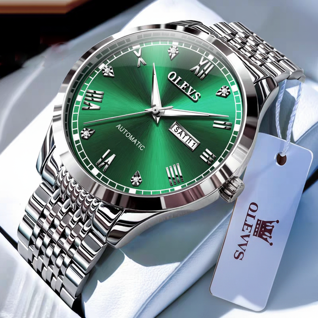 Green watch with silver case and band on a white surface, accompanied by a tag and small gift box.